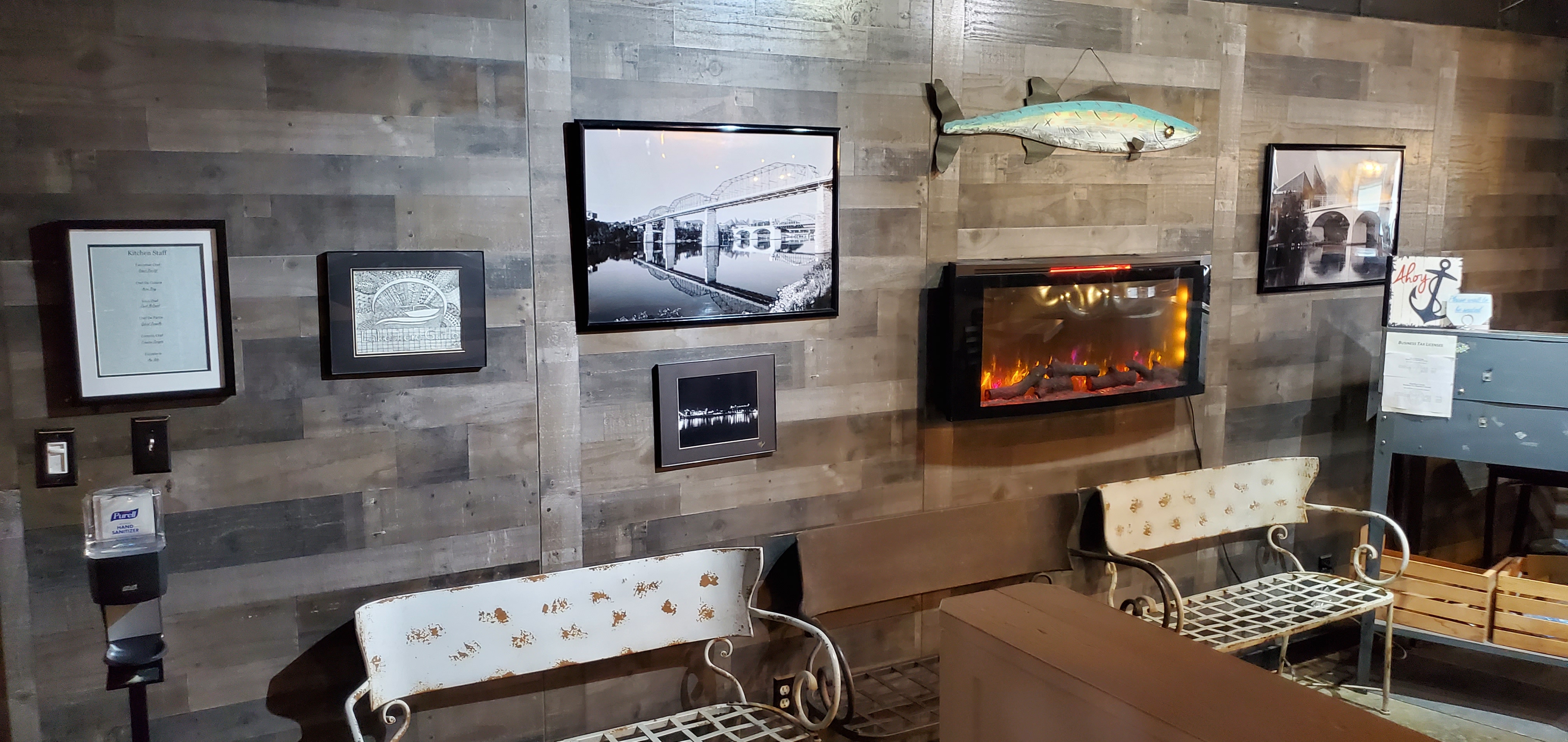Wall with photos, a fish, and an e-fireplace